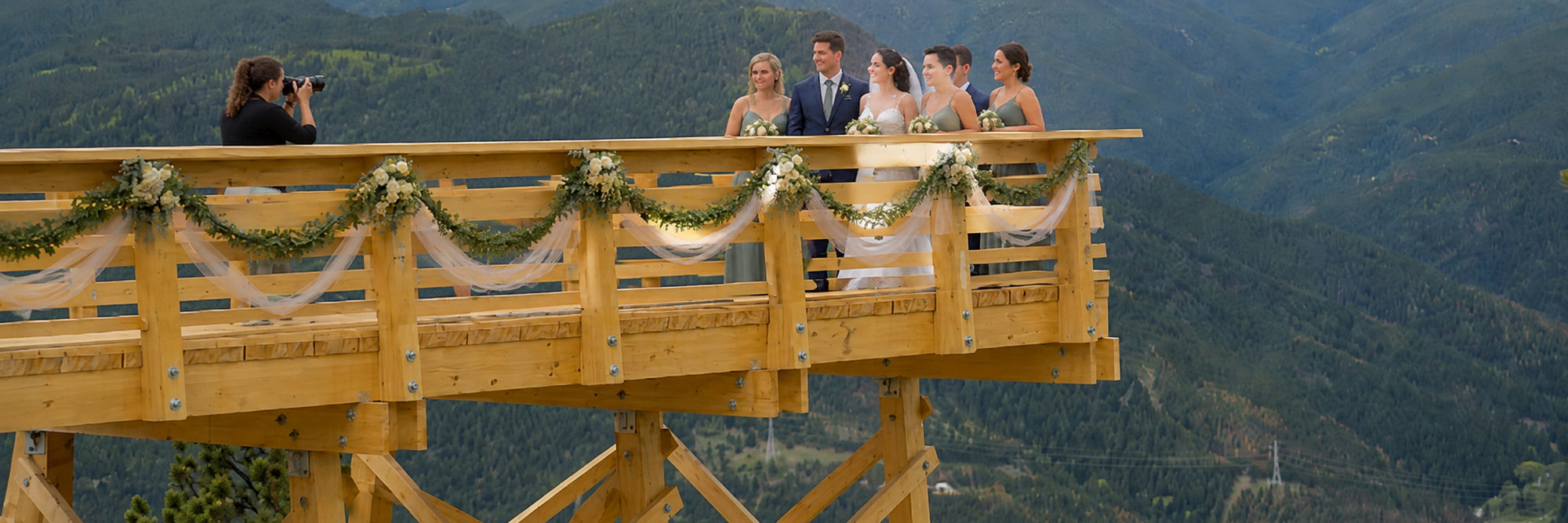 A wedding party on the Argo overlook trestle, the canyon and forested ridges behind them